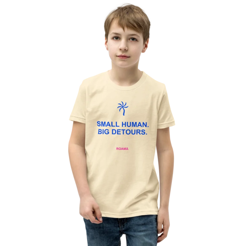 Kids quote tee in Small human. Big detours. · Natural, Natural — supplier product mockup
